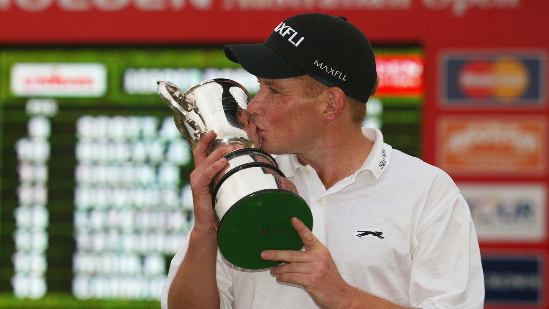 Stephen Allan hoists the Holden Australian Open trophy in 2002.